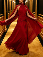 Red ruched halter cape maxi dress, front view.