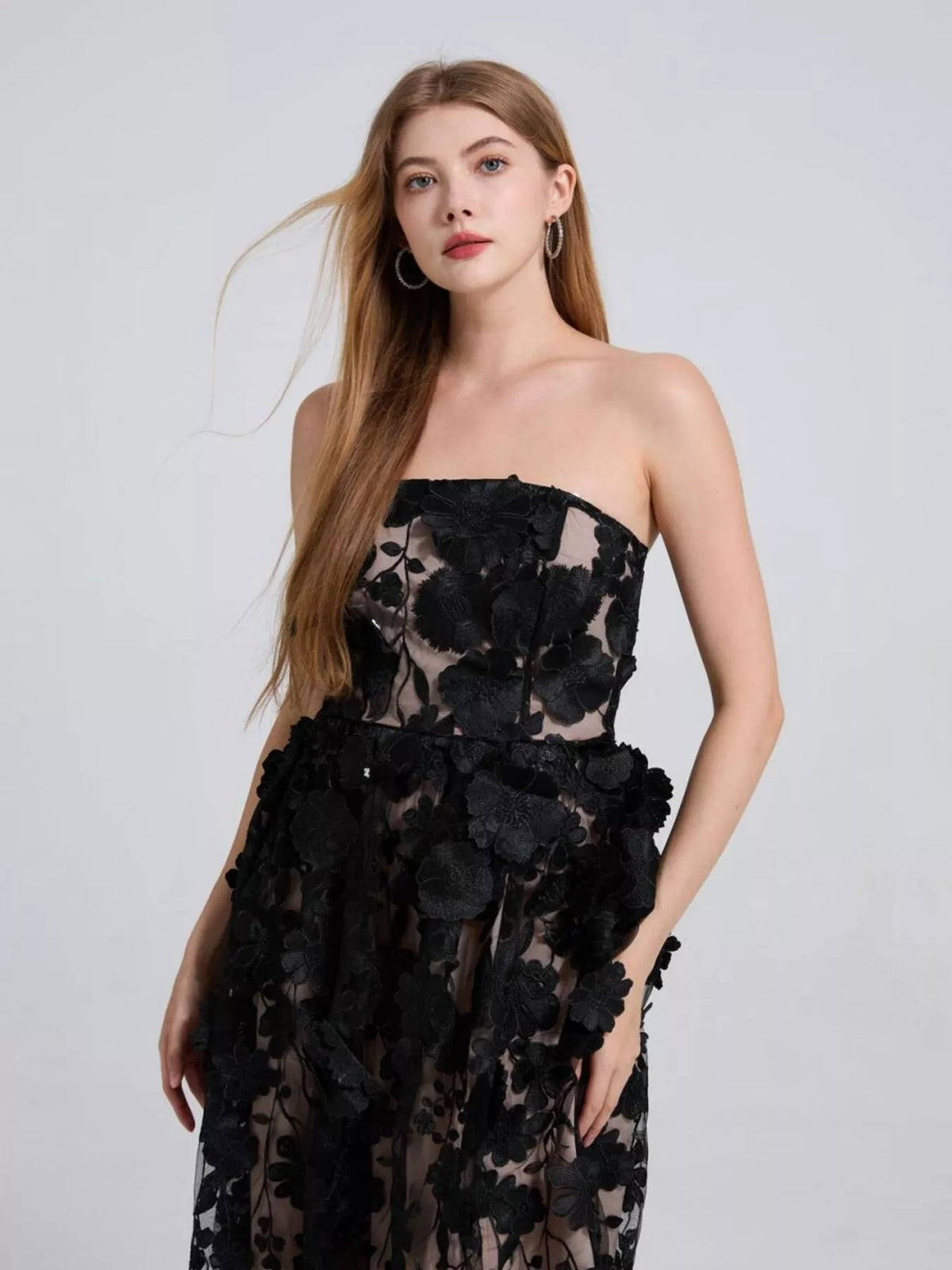 Black floral appliqué strapless midi dress, front view.