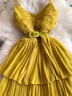 Mustard yellow pleated layered spaghetti-strap midi dress, waist detail.