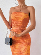 Orange printed strapless side-slit maxi dress, neckline detail.