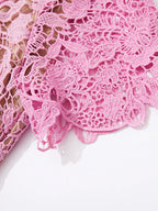 Pink lace button-up midi dress with pockets, hem detail.