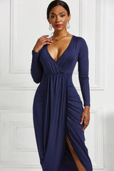 Navy ruched long-sleeve wrap dress, front view with asymmetric hem
