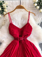 Red pleated layered spaghetti-strap midi dress, bodice detail.