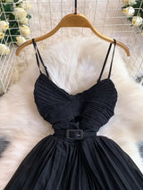 Black pleated layered spaghetti-strap midi dress, bodice detail.