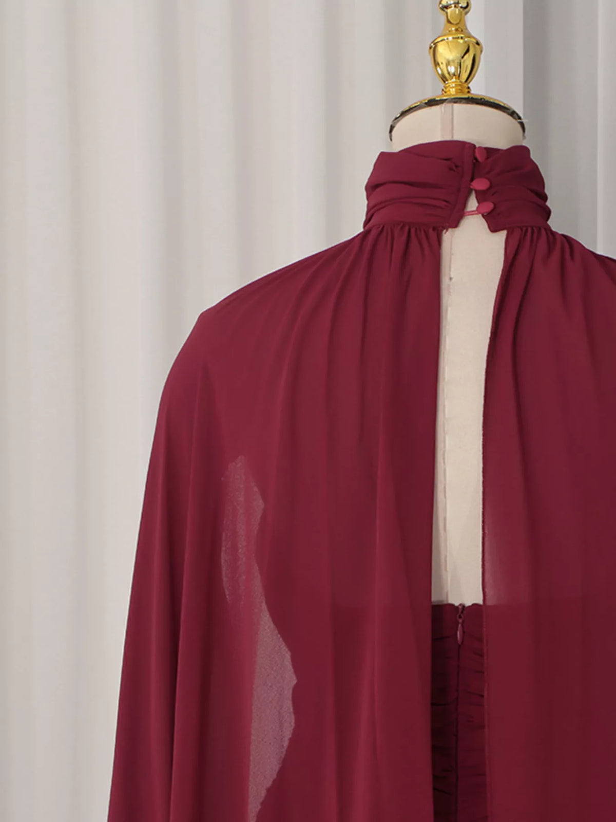 Burgundy ruched halter cape maxi dress, back neckline detail.