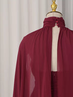 Burgundy ruched halter cape maxi dress, back neckline detail.