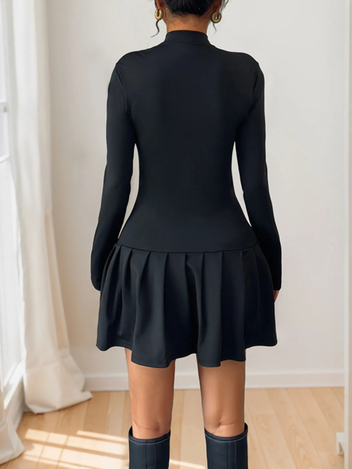 Black mock-neck long-sleeve mini dress, back view.