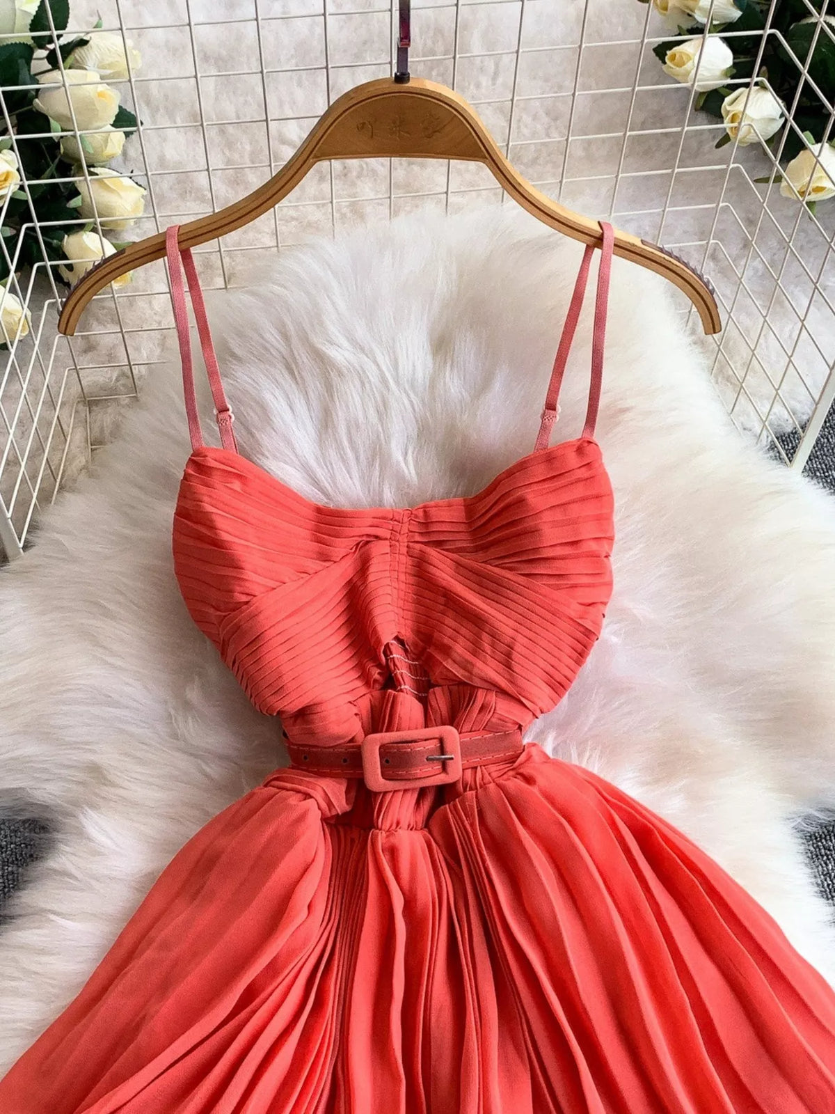 Coral pleated layered spaghetti-strap midi dress, bodice detail.