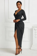Black ruched long-sleeve wrap dress, front view with asymmetric hem