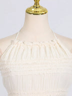 Ivory ruched halter neck maxi dress, neckline detail.