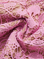 Pink lace button-up midi dress with pockets, lace detail.