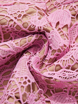 Pink lace button-up midi dress with pockets, lace detail.