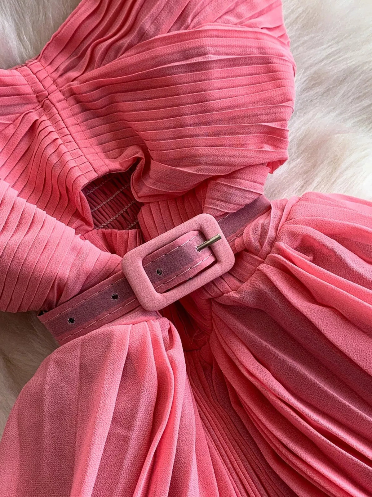 Pink pleated layered spaghetti-strap midi dress, waist detail.