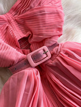 Pink pleated layered spaghetti-strap midi dress, waist detail.