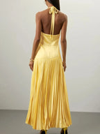 Yellow pleated halter-neck maxi dress, back view.