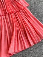 Pink pleated layered spaghetti-strap midi dress, pleat detail.