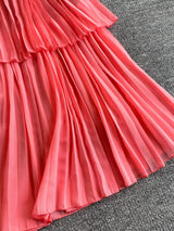 Pink pleated layered spaghetti-strap midi dress, pleat detail.