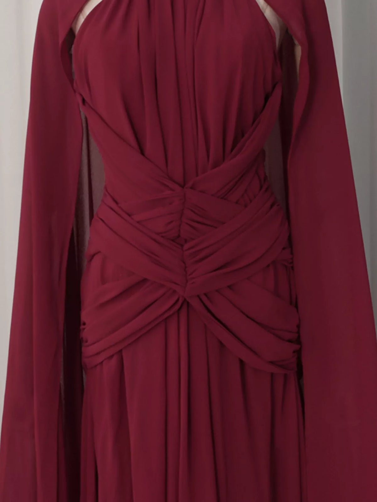 Burgundy ruched halter cape maxi dress, waist detail.