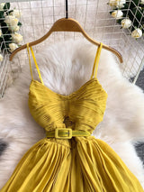 Mustard yellow pleated layered spaghetti-strap midi dress, bodice detail.