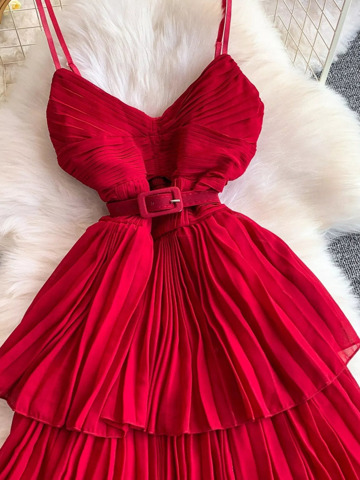 Red pleated layered spaghetti-strap midi dress, waist detail.