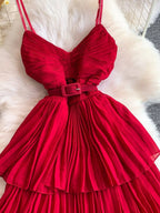 Red pleated layered spaghetti-strap midi dress, waist detail.