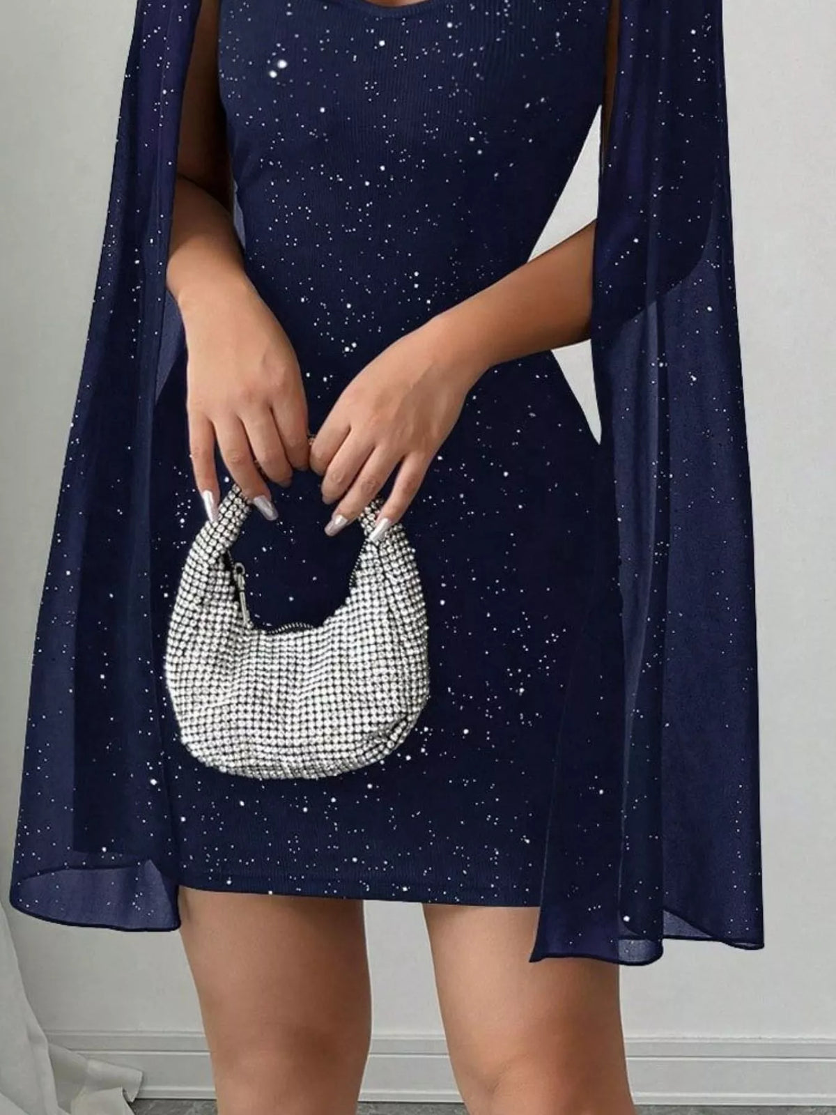 Navy glitter cutout bodycon mini dress with cape sleeves, skirt detail.
