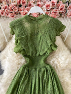 Green ruffled mock-neck lace maxi dress, front view.