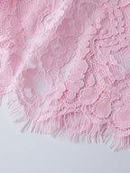 Pink lace long-sleeve midi dress, hem detail.