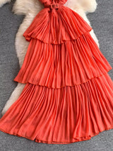 Coral pleated layered spaghetti-strap midi dress, skirt detail.