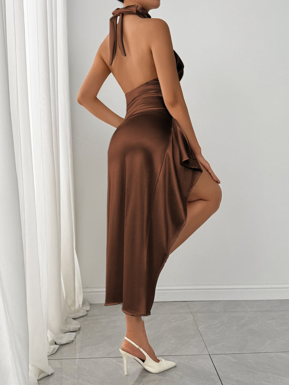 Brown ruched halter dress with high slit, back view