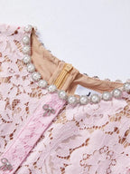 Pink short-sleeve lace mermaid midi dress, neckline detail.
