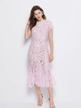 Pink short-sleeve lace mermaid midi dress, front view.
