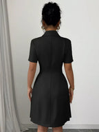 Black double-breasted pleated blazer mini dress, back view.