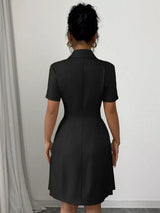 Black double-breasted pleated blazer mini dress, back view.