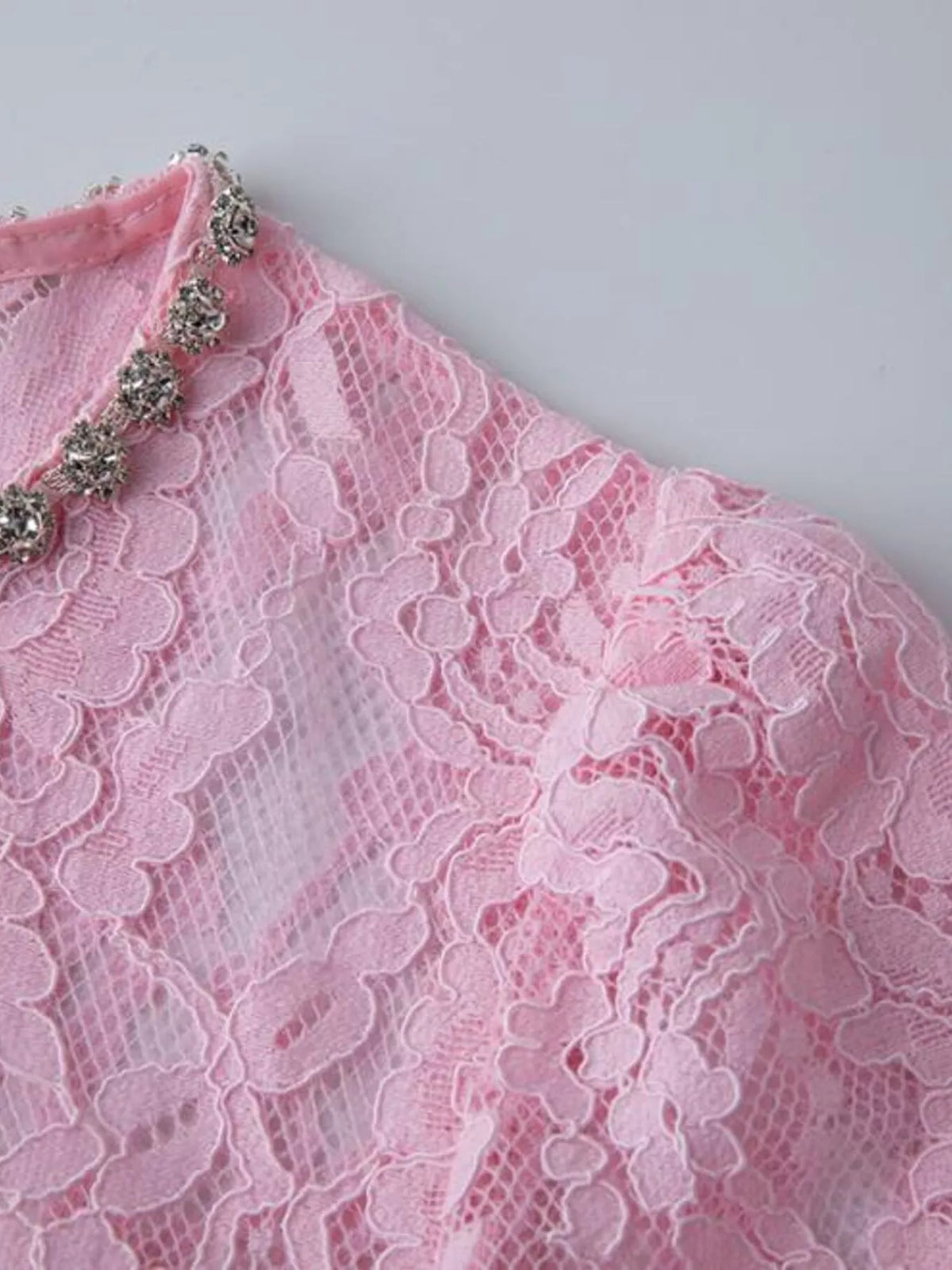 Pink lace long-sleeve midi dress, shoulder detail.