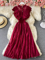 Burgundy ruffled mock-neck lace maxi dress, front view.