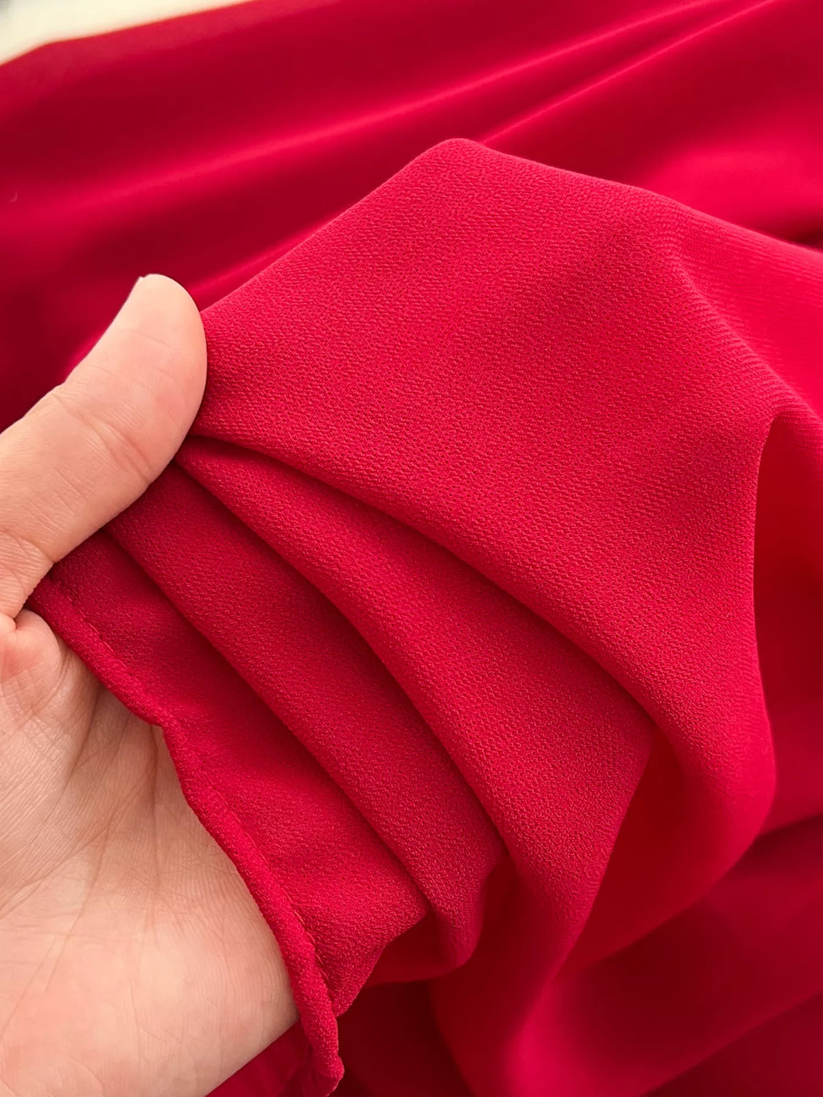 Red one-shoulder floral decor dress, fabric close-up.