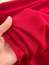 Red one-shoulder floral decor dress, fabric close-up.