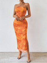 Orange printed strapless side-slit maxi dress, front view.