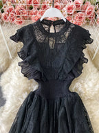 Black ruffled mock-neck lace maxi dress, bodice detail.