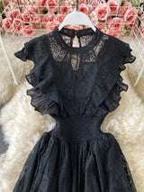Black ruffled mock-neck lace maxi dress, bodice detail.