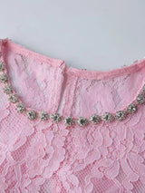 Pink lace long-sleeve midi dress, neckline detail.