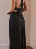 Black halter neck wrap maxi dress with tie detail, back view.