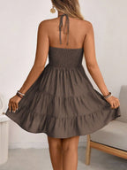 Brown smocked halter tiered mini dress, back view