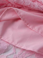 Pink lace long-sleeve midi dress, lining detail.