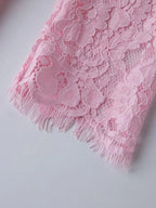 Pink lace long-sleeve midi dress, cuff detail.