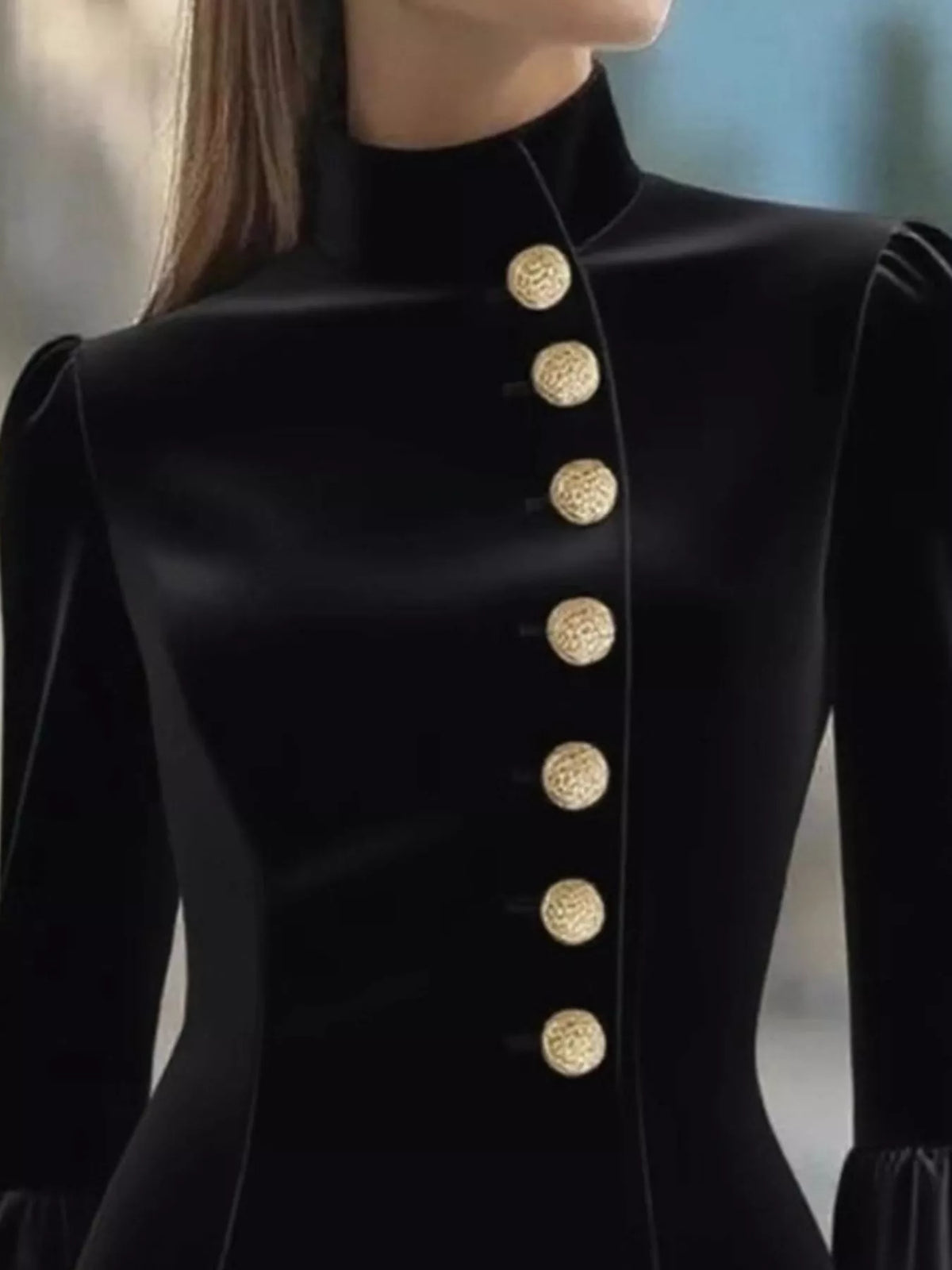 Black ruffled bell-sleeve mini dress, neckline detail.