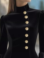 Black ruffled bell-sleeve mini dress, neckline detail.
