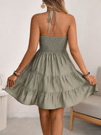 Sage-green smocked halter tiered mini dress, back view