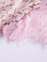 Pink short-sleeve lace mermaid midi dress, hem detail.